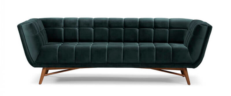 Modern charcoal coloured velvet couch with crossbeam wooden legs, on a white background